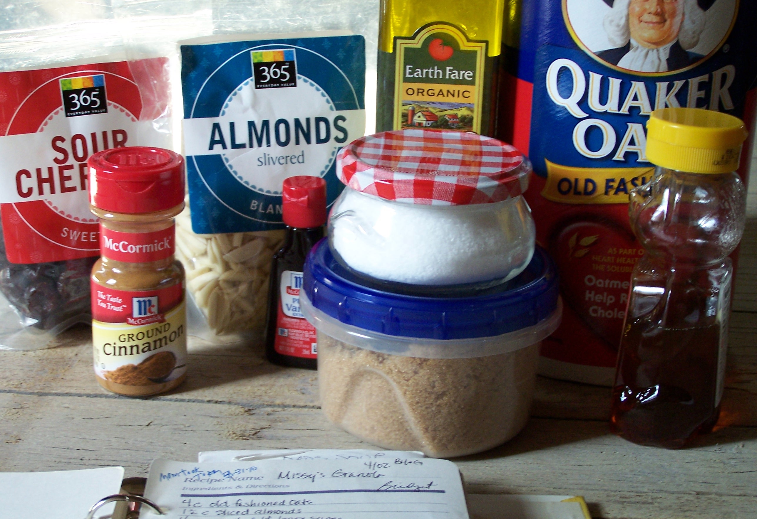 ingredients for granola, sour cherries, almonds, oatmeal, olive oil, brown sugar, honey, vanilla, cinnamon