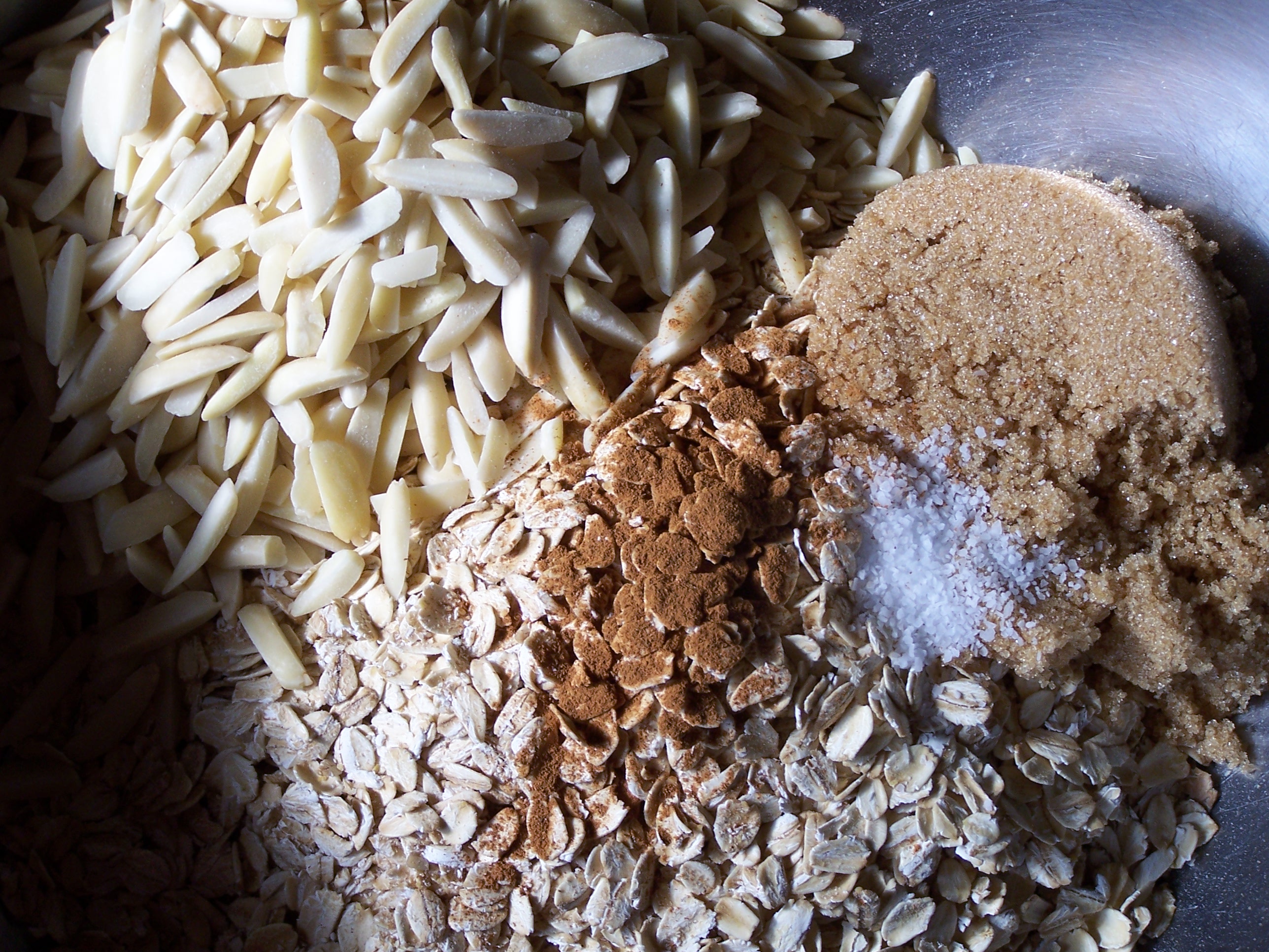 almonds, brown sugar, cinnamon, oatmeal, salt, ingredients in a bowl