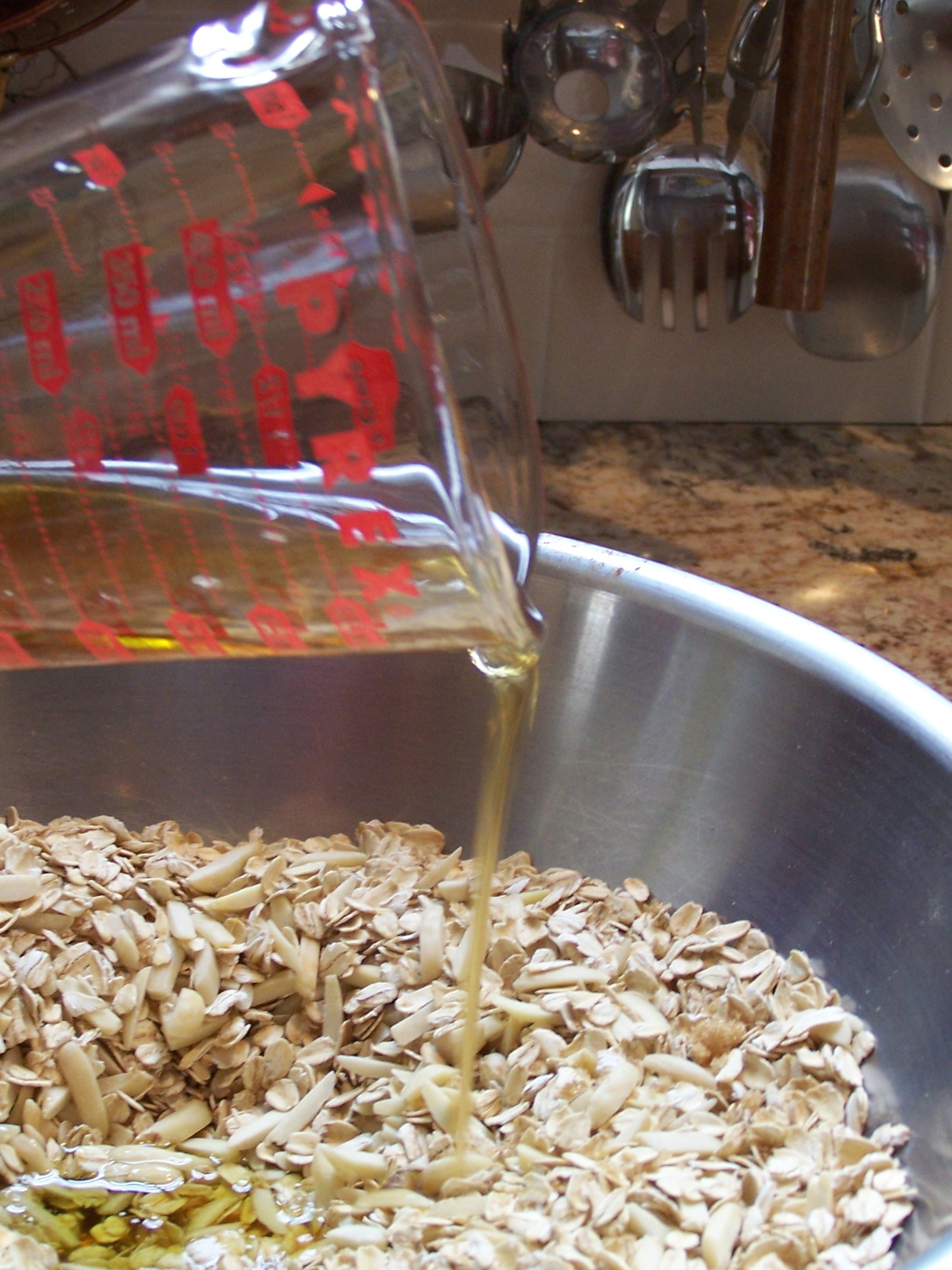 oatmeal ingredients in bowl, honey and olive oil mixture being poured into it