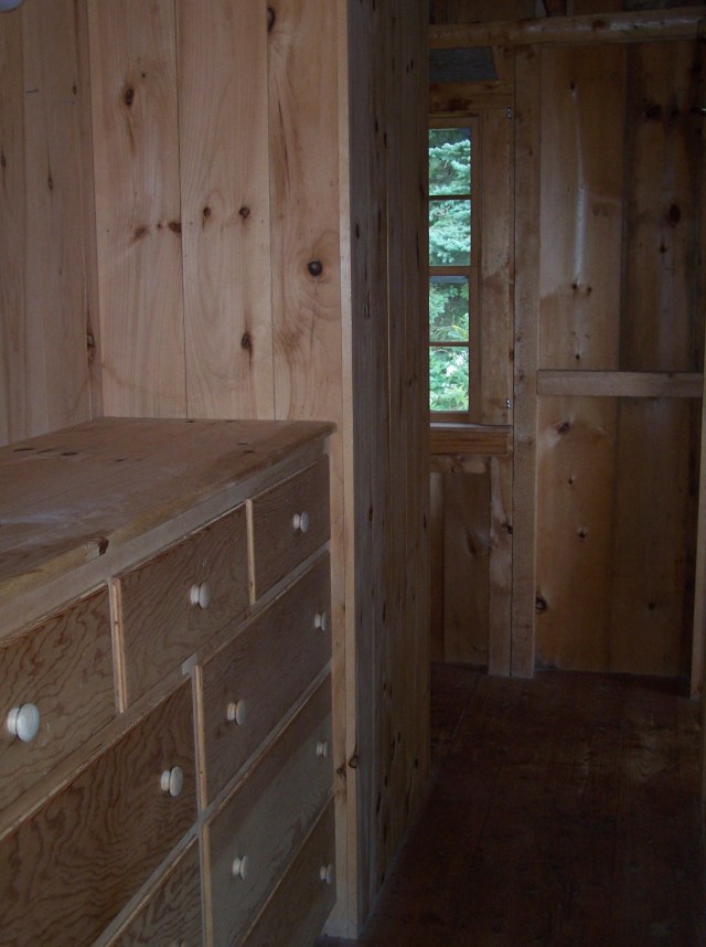 Built in storage in wall behind bed