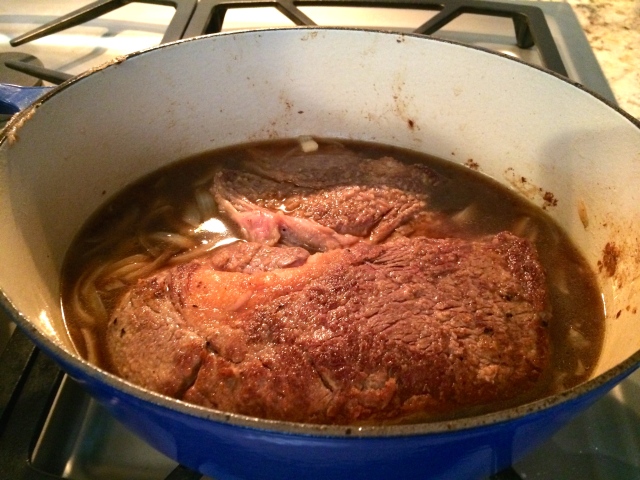Add seared roast and beef broth to pan