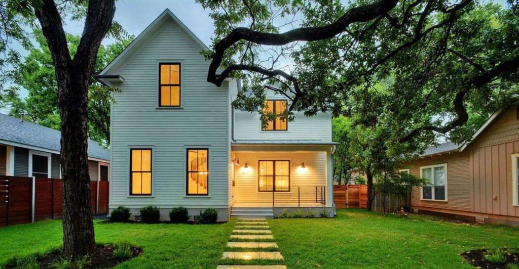 Alderney house plan in real life, white 2 story house, black windows, low hanging tree, green rass