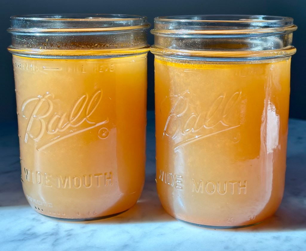 Ball Canning Jar with homemade vegetable broth, 2 jars on a table
