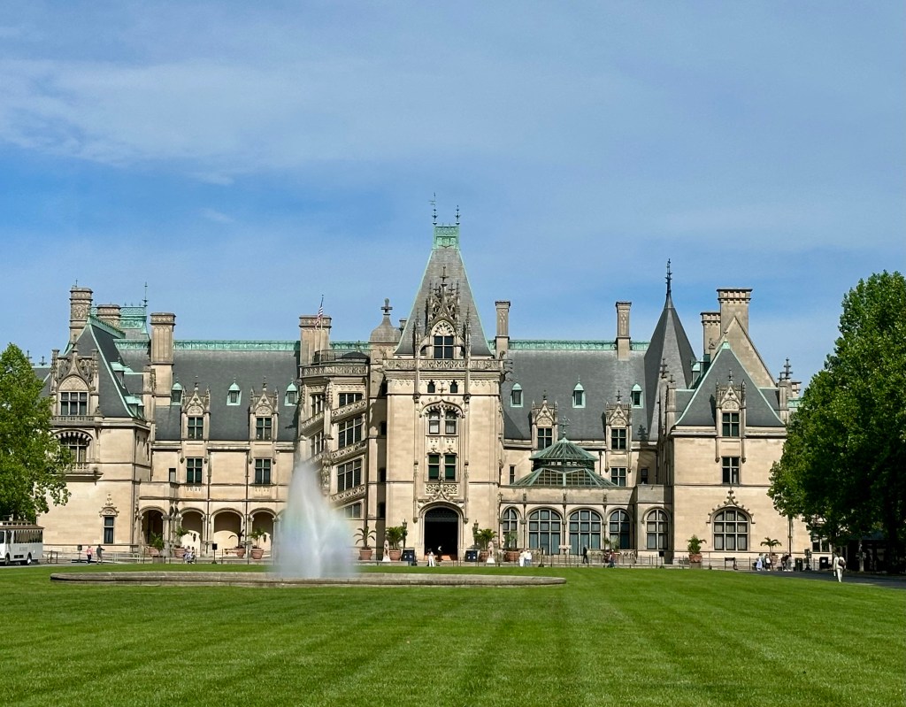 The oh so grand Biltmore Estate, image taken from front lawn, fountain blowing in the wind