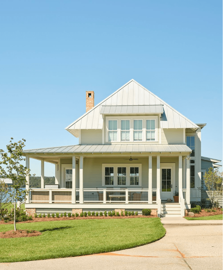 two story house on lake, nice roof lines, green grass, trees