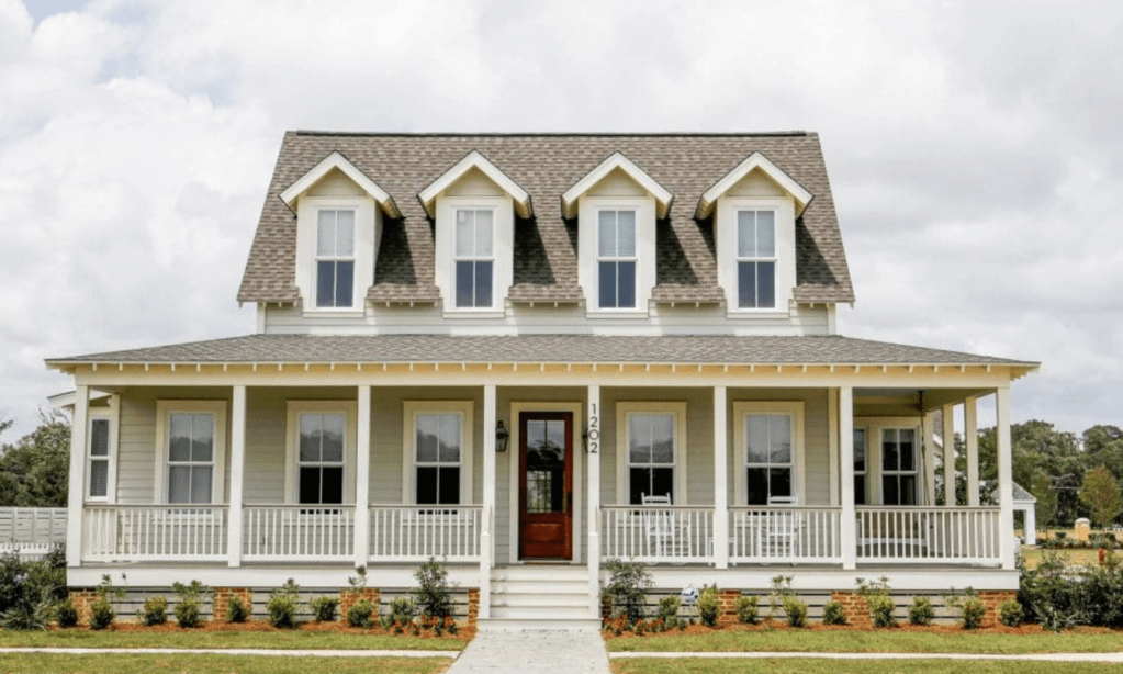 Beautiful house with large front porch dormer windows on second floor and side porch