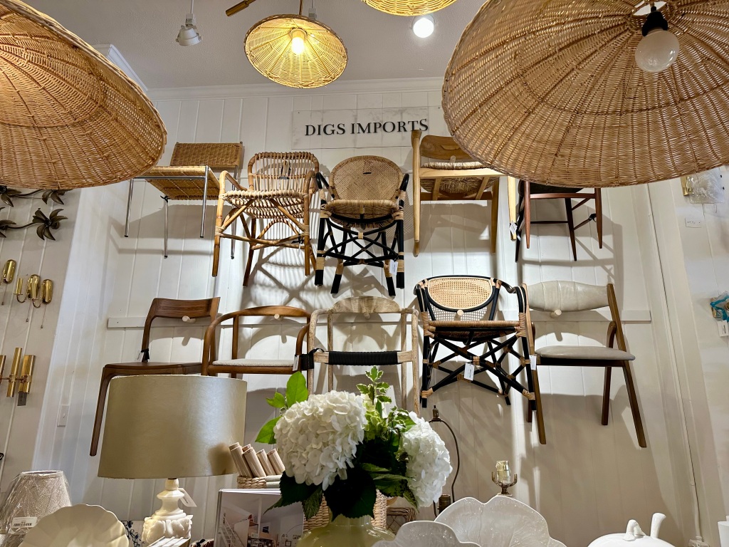 Digs Charleston interior with chairs hanging on the wall, cool light fixtures, wonderful furniture, lighting and everything in between.